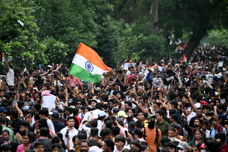 Cockroach Janta Party (CJP) supporters celebrate the resignation of India's Education Minister Dharmendra Pradhan at Jantar Mantar in New Delhi on Saturday.Sajjad Hussain / AFP via Getty Images