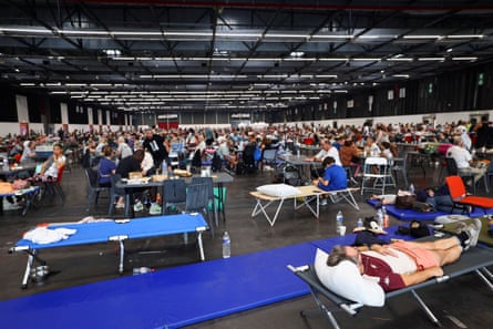 People who have been evacuated from their homes in the Bordeaux-Lac exhibition centre, which has been turned into a shelter for displaced people.Photograph: Manon Cruz/Reuters