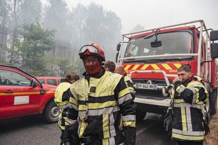 Firefighters on a support line between the villages of Lacanau and Saint-Hélène in the Bordeaux region.Photograph: Astrid Lagougne/EPA