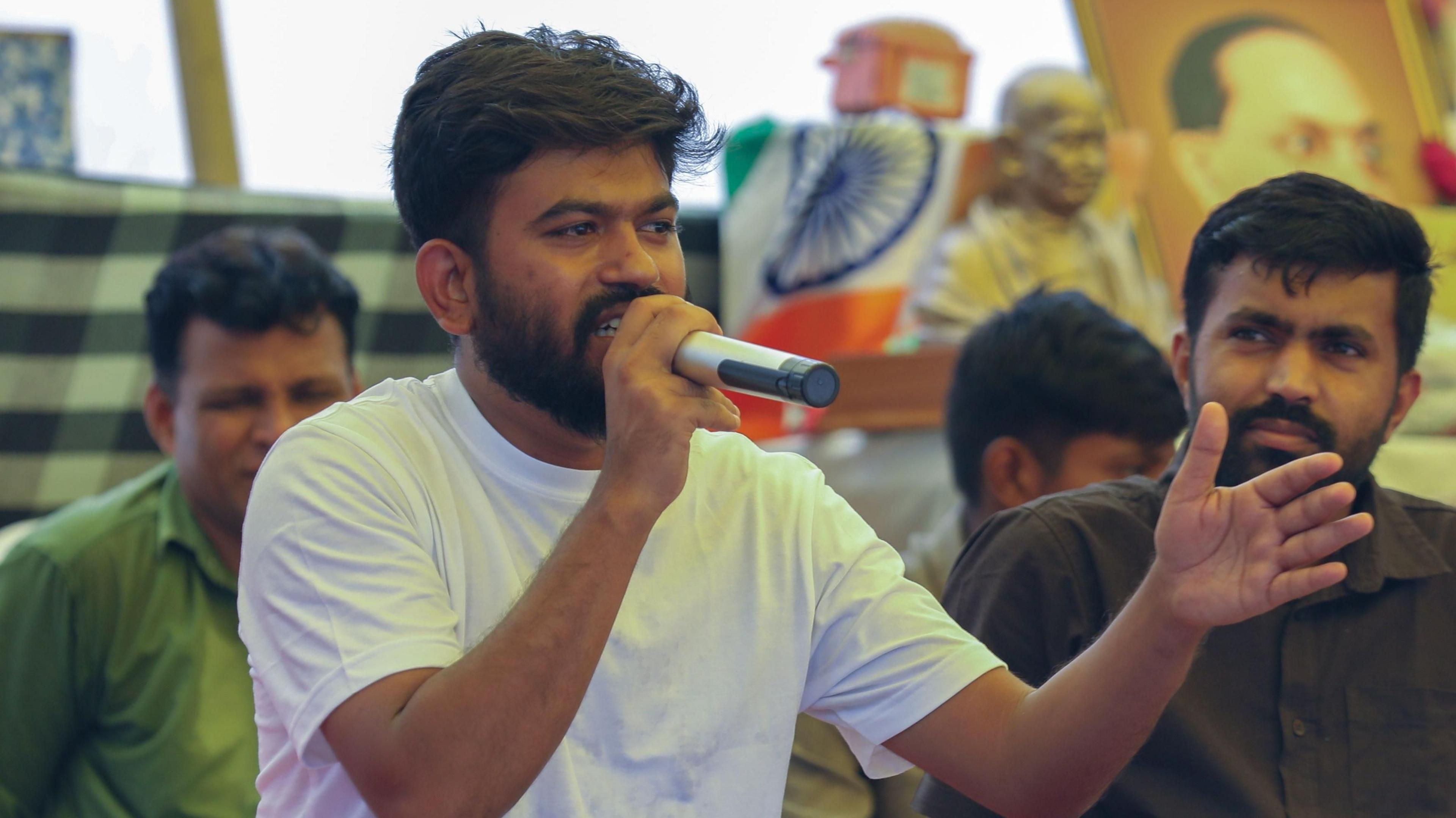 Image caption,CJP founder Abhijeet Dipke speaks at a demonstration in Delhi on Saturday