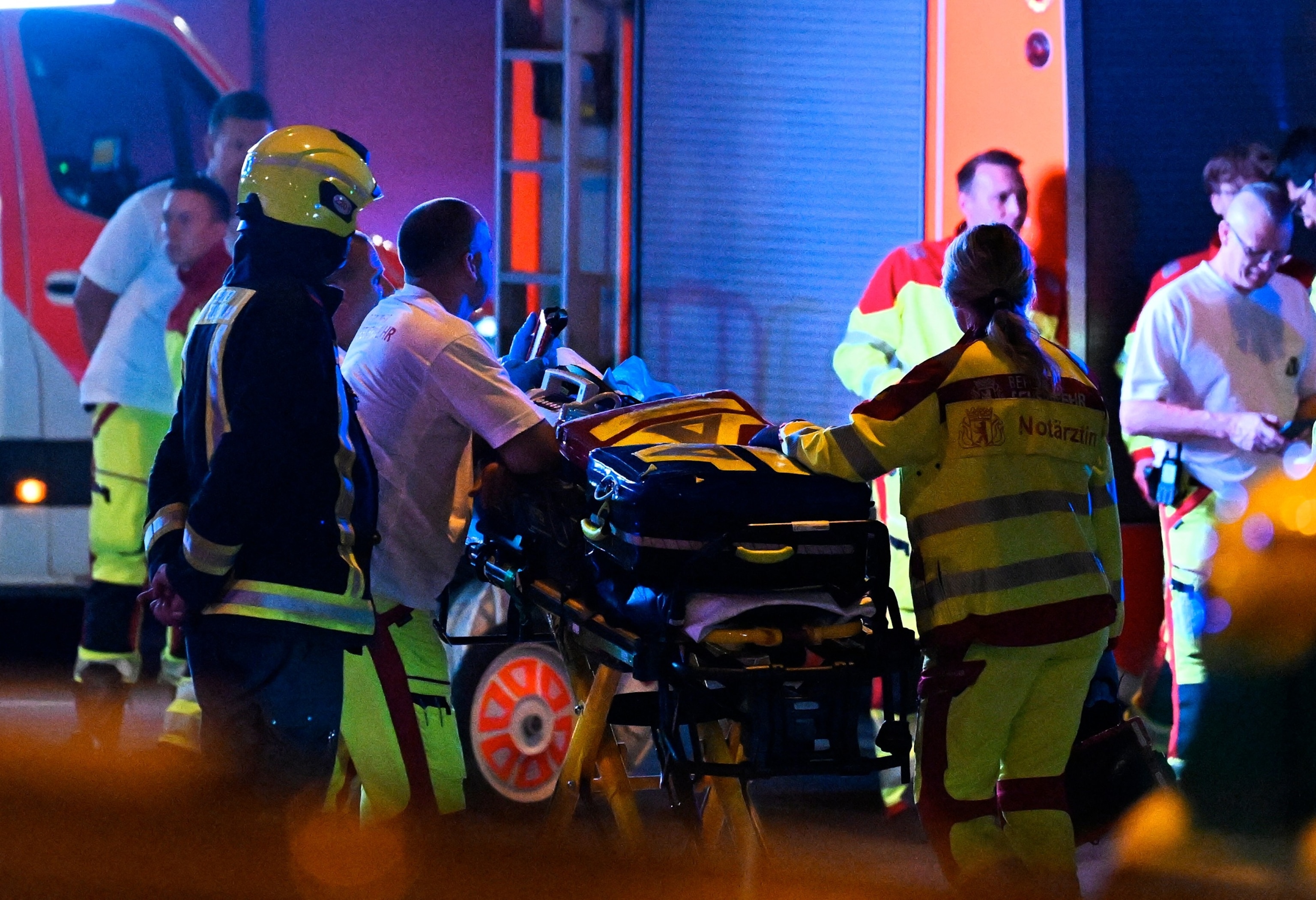 Emergency personnel and police work near the scene where one person was killed and around 15 injured after a car is believed to have hit the crowd on the outskirts of the Christopher Street Day (CSD) parade in Berlin, on July 25, 2026.Ralf Hirschberger/AFP via Getty Images