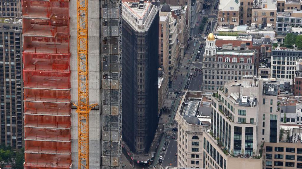 Image caption,The Flatiron Building, seen here in 2023, was covered in dark scaffolding for years