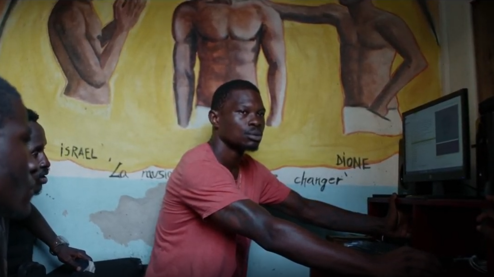 Image caption,Stone (R), a former soldier in the presidential guard, raps and produces music with Jail Time Records