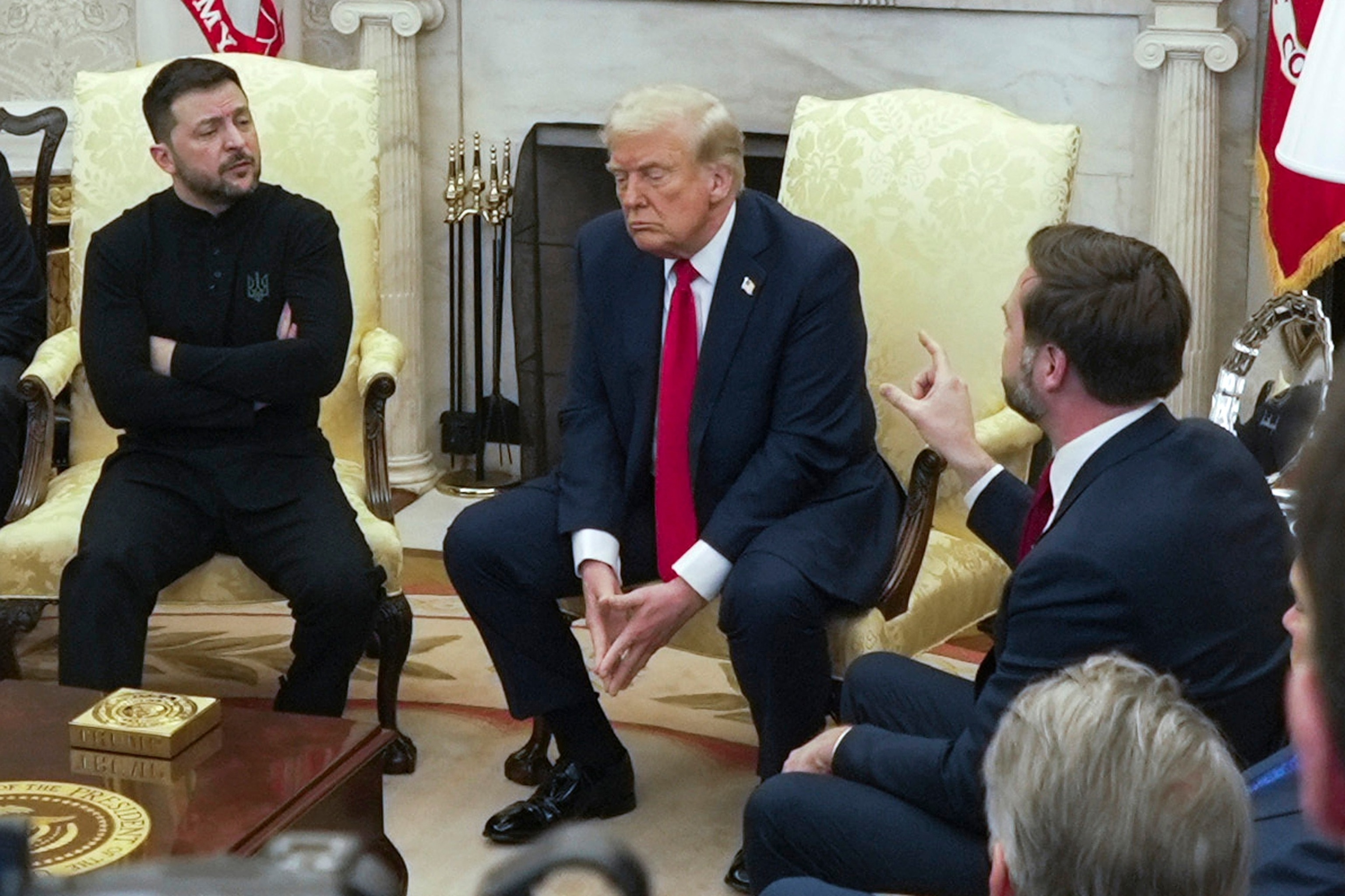 Vice President JD Vance, right, speaks with Ukrainian President Volodymyr Zelenskyy, left, as President Donald Trump listens in the Oval Office at the White House, Feb. 28, 2025, in Washington.Mystyslav Chernov/AP