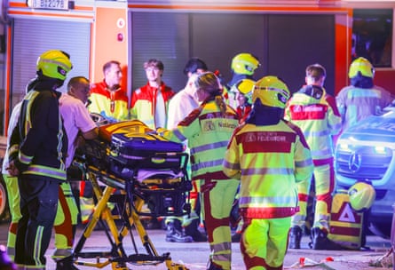 Emergency personnel work near the scene where a group of people were injured.Photograph: Clemens Bilan/EPA