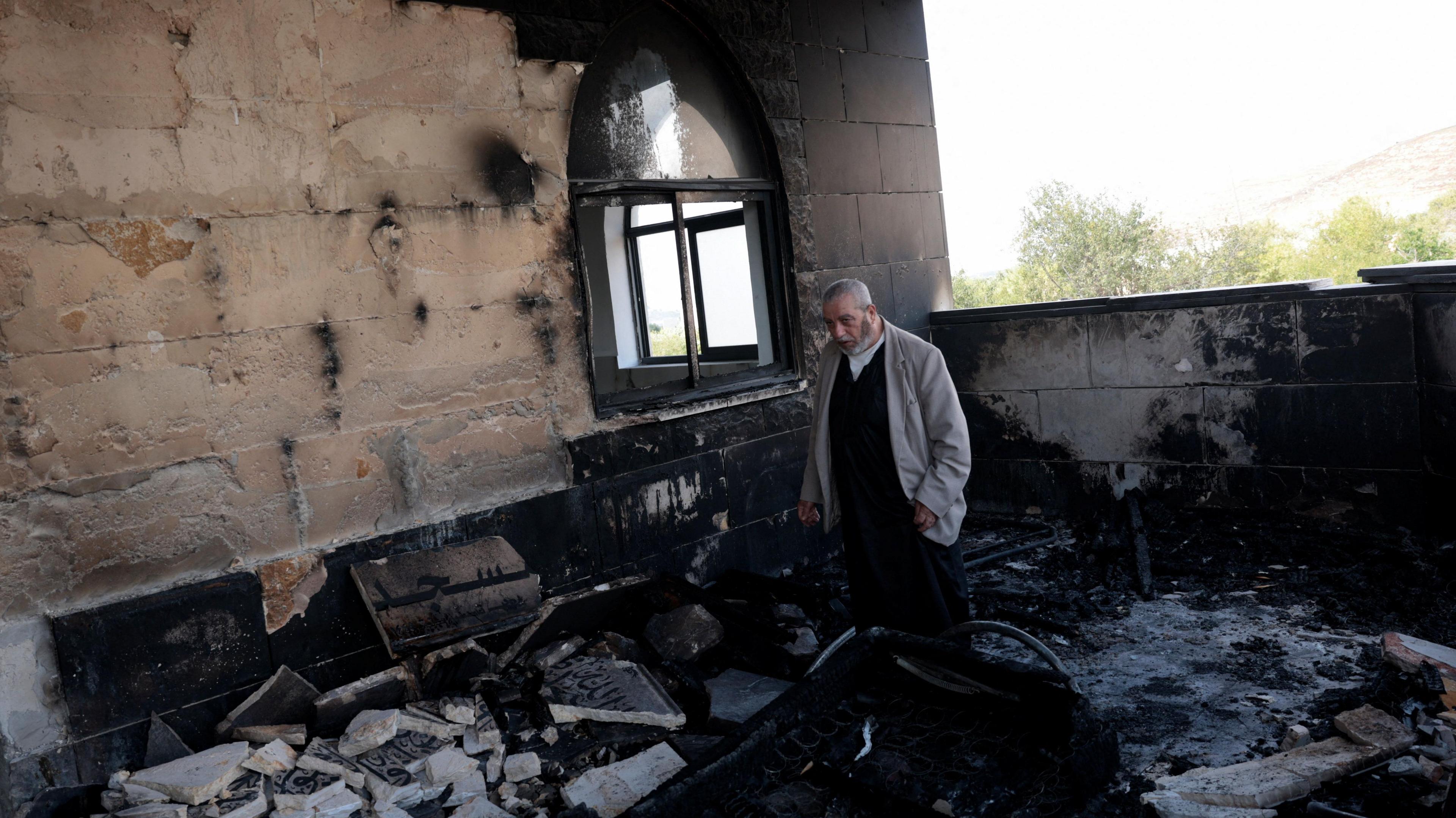 Image caption,Graffiti was visible on the outside walls of the mosque, which was damaged by fire