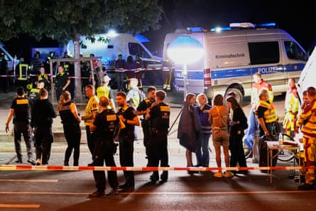 Emergency personnel and police gather in Berlin.Photograph: Ebrahim Noroozi/AP