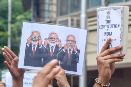 Many CJP supporters brought placards and signs openly criticising Modi.Photograph: Divyakant Solanki/EPA