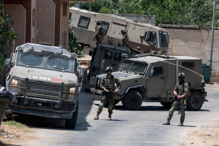 Israeli army units stage a raid near Nablus in the occupied West Bank after the deaths of four Palestinians and two Israelis when armed settlers entered a village.Photograph: Mohammed Torokman/Reuters