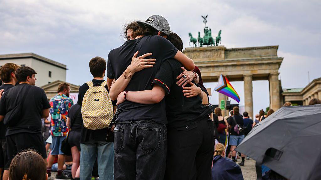 Image caption,Mourners gather near the Brandenburg Gate on Sunday