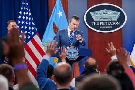 Reporters raise their hands to ask questions during a briefing on the Iran war with Pete Hegseth at the Pentagon in Washington DC on 16 April.Photograph: Nathan Howard/Reuters
