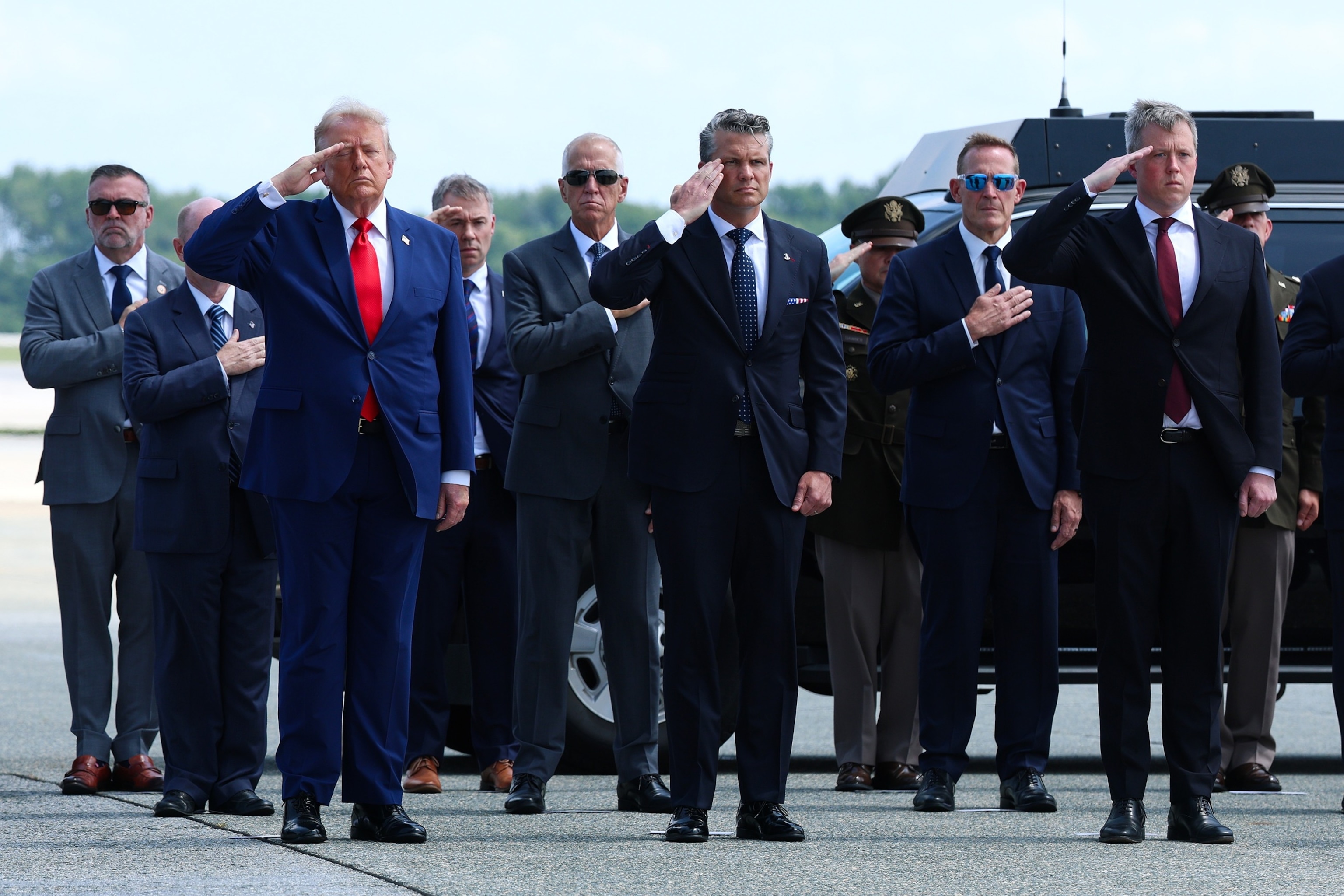 President Donald Trump and Secretary of War Pete Hegseth salute as members of a U.S. Army carry team move the flag-draped transfer case holding the remains of Army Staff Sgt. Michael Emmanuel Swinton during a dignified transfer at Dover Air Force Base, July 22, 2026 in Dover, Delaware.Kevin Dietsch/Getty Images