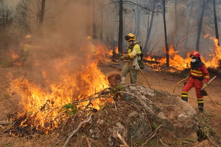 Flames spread through a forest in Ávila, Spain.Photograph: César Manso/AFP/Getty Images