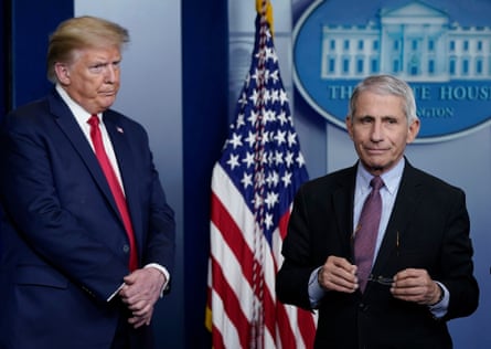 Anthony Fauci and Donald Trump participate in the daily coronavirus taskforce briefing at the White House on 22 April 2020.Photograph: Drew Angerer/Getty Images