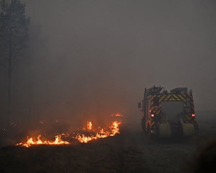 A fire engine drives through smoke near Marcheprime outside Bordeaux.Photograph: Emma Da Silva/AP