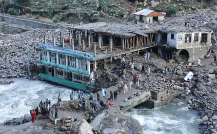 Residents and rescue workers inspect buildings damaged by heavy flooding in the eastern province of Nuristan, Afghanistan.Photograph: Wahidullah Kakar/AP