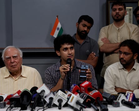Saurav Das, a spokesperson for the Cockroach movement, addresses a press conference in New Delhi on Monday as his co-spokesperson, Ashutosh Ranka, and Kapil Sibal, an Indian lawmaker, look on.Photograph: Priyanshu Singh/Reuters