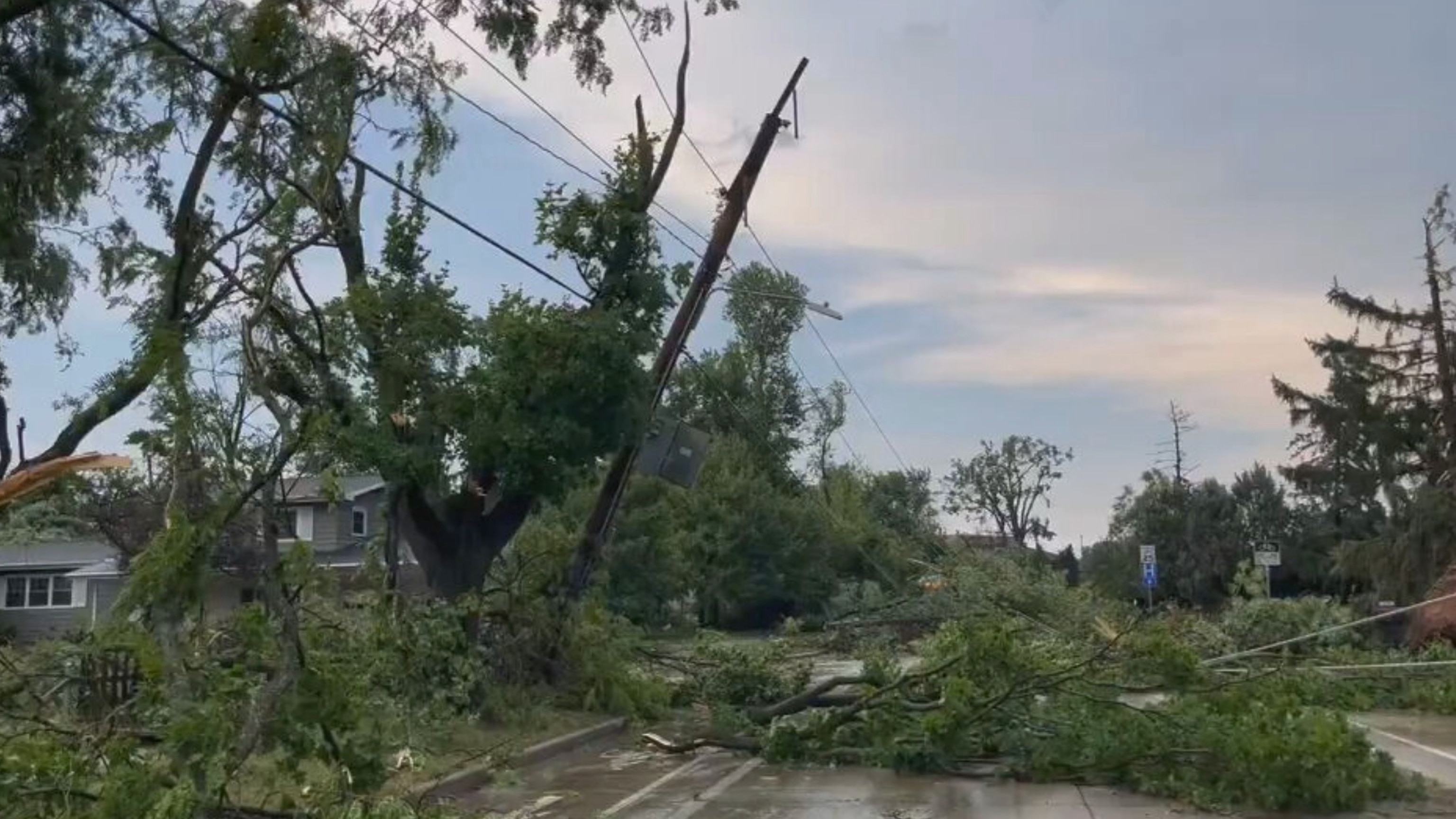Damaged trees and power lines litter a street in Appleton, Wisc., July 27, 2026.WBAY
