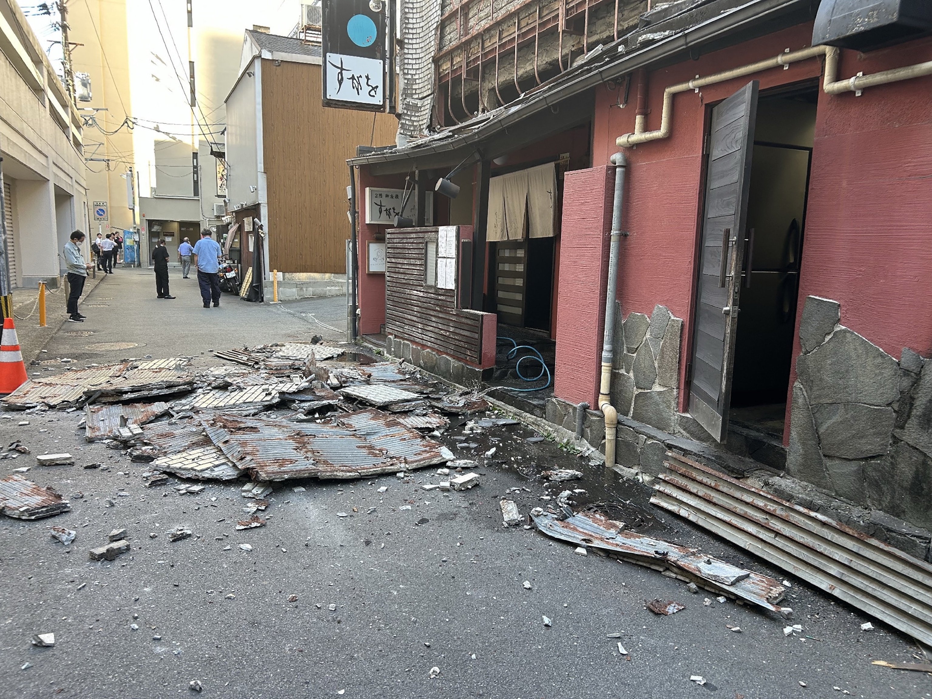 Reporters watch the news showing a large quake and possible one meter tsunami wave in Southern Japan, from an office in Tokyo on July 28, 2026.Andrew Caballero-reynolds/AFP via Getty Images