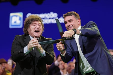 Flávio Bolsonaro, right, joins Javier Milei on stage at a Liberal party convention in São Paulo, Brazil on Saturday.Photograph: Ettore Chiereguini/AP