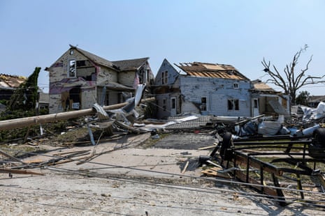 A resident inspects the damage amid debris and a destroyed home a day after a tornado ripped through Menasha, Wisconsin, on Tuesday.Photograph: Octavio Jones/AFP/Getty Images