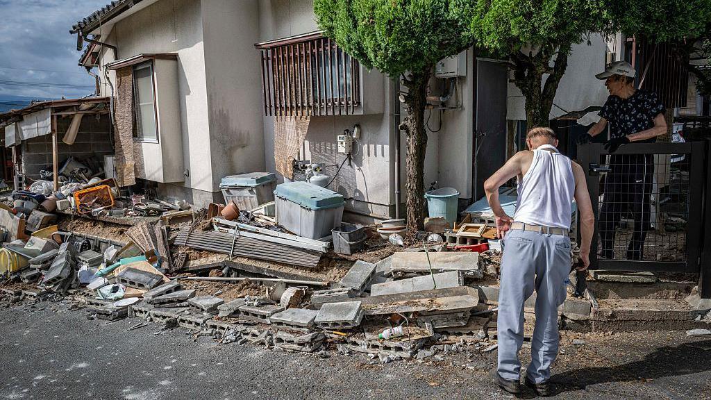 Image caption,Many people are left with no choice but to pick up the pieces, even as fear of another earthquake lingers