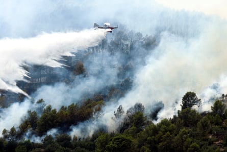 A firefighting plane makes a drop amid efforts to battle a wildfire in Artana, Spain on Wednesday.Photograph: Pedro Nunes/Reuters