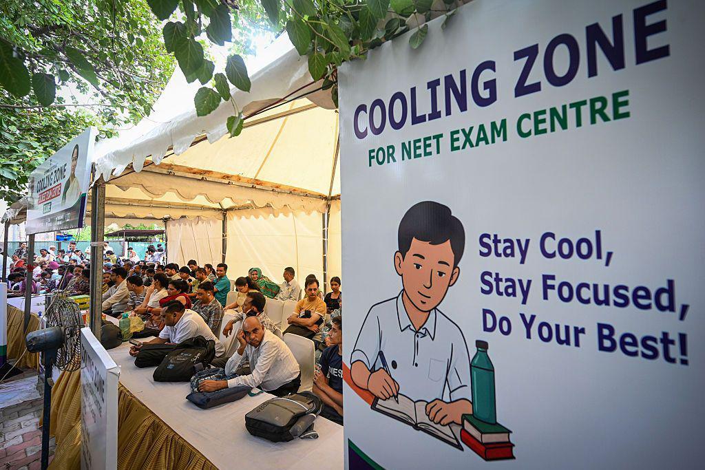 Image caption,Parents of candidates wait at a cooling station outside a centre in Delhi - NEET is one of the most competitive exams in the world