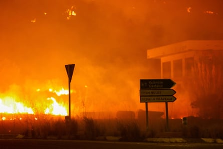 A wildfire approaches a building in Castellon, Spain, on 25 July.Photograph: Eva Manez/Reuters