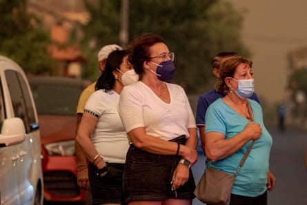 Residents try to shield themselves from the toxi smoke in Avila, Spain.Photograph: Anadolu/Getty Images