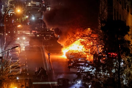 Cars burn in a Tehran street during a January protest which began over the collapse of the currency’s value.Photograph: Reuters