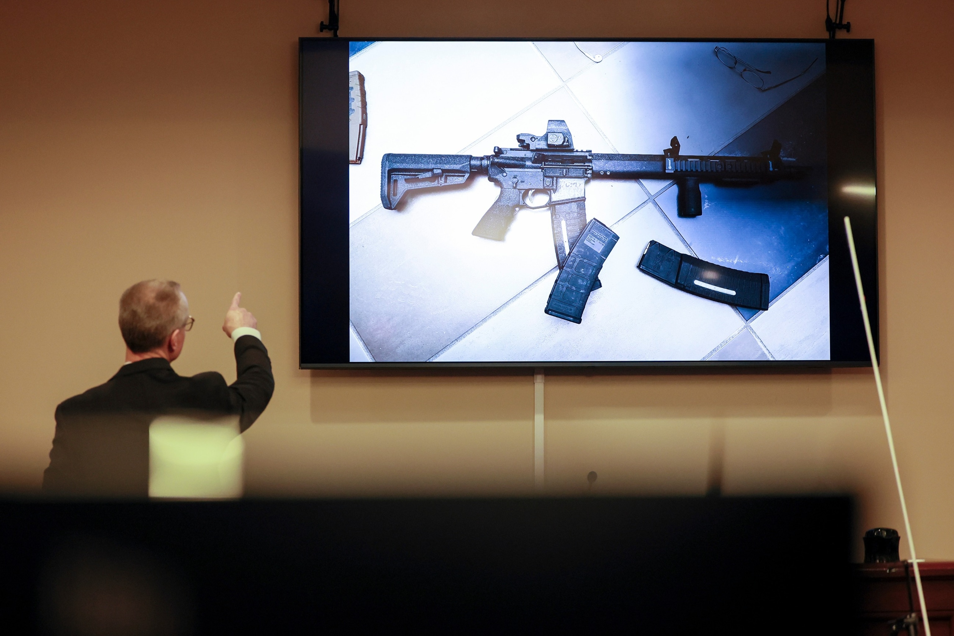 District Attorney Brad Smith, left, points to a weapon that was displayed on the screen during the first day of the trial of Colin Gray, the father of Apalachee High School shooting suspect Colt Gray, February 16, 2026.Jason Getz/AP