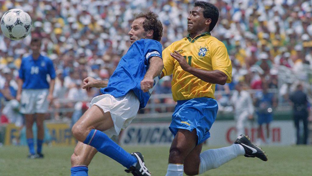 Image caption,Baresi captained Italy in the World Cup final in 1994, just three weeks after having surgery on his right knee. Here, he clears the ball under pressure from Brazil's Romario