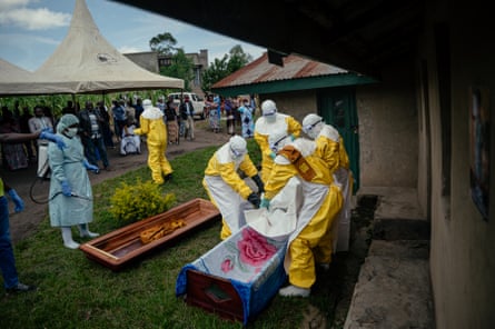 Members of a Congolese Red Cross team in Bunia carry the body of a woman suspected of having died from Ebola, 7 June.Photograph: Jospin Mwisha/AFP/Getty Images