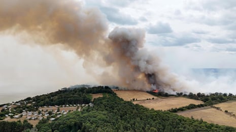Emergency services near the scene of the wildfire on Friday.Photograph: Humphrey Nemar/PA