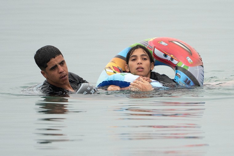 Migrants swam around border barriers with Morocco to enter the Spanish territory.Jorge Guerrero / AFP via Getty Images