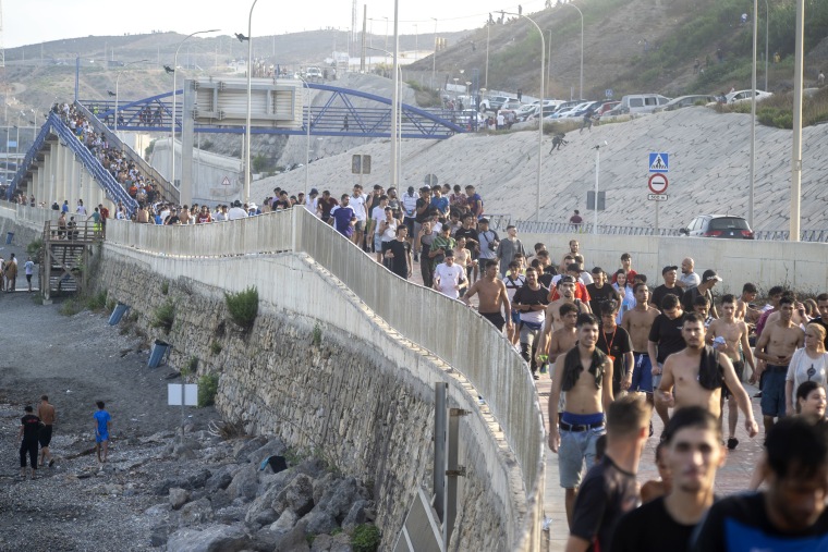 Dozens of migrants celebrated having crossed the border between Ceuta and Morocco.Marcos Moreno / Europa Press via Getty Images