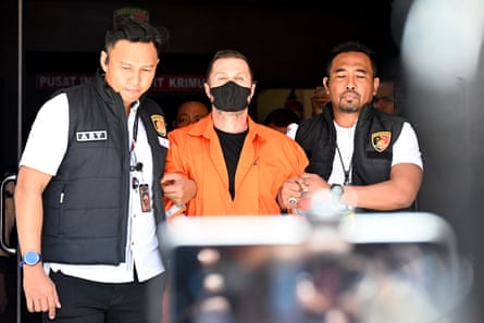 Steven Lyons is escorted by police officers at the Bali police headquarters in Denpasar, Indonesia, on 31 March.Photograph: Sonny Tumbelaka/AFP/Getty