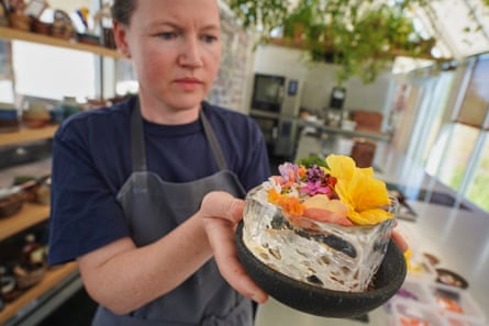 Noma’s head of research and development, Mette Brink Søberg, with a new gazpacho dish topped with flower petals.Photograph: James Brooks/AP