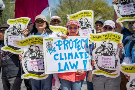 Participants seen holding signs at a rally at Union Square Park in Manhattan in April against Governor Kathy Hochul’s attempt to weaken the state’s climate law.Photograph: Erik McGregor/LightRocket/Getty Images