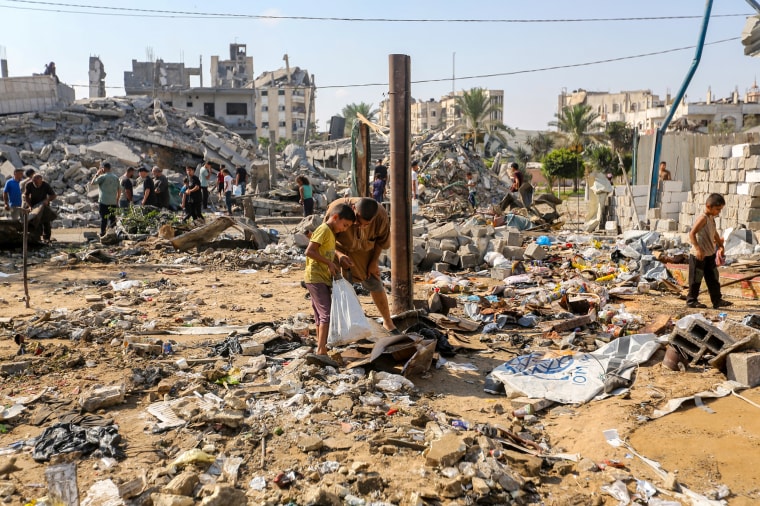 Residents inspect the damage caused by Israeli airstrikes last night on residential buildings in the Safatawi area of Gaza on Aug. 1.Ahmad Hasaballah / Getty Images