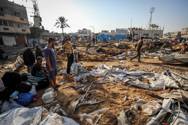Displaced Palestinians inspect the destruction following an Israeli airstrike that targeted the central Gaza Strip on Aug. 1.Majdi Fathi / NurPhoto via Getty Images