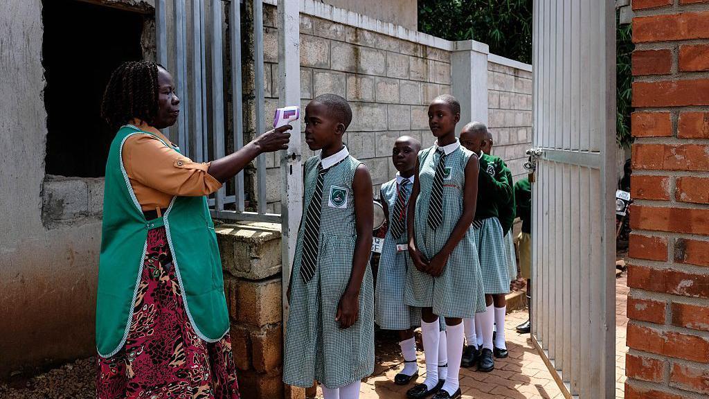 Image caption,At-risk communities in Uganda have complied with prevention efforts, a government spokesperson says
