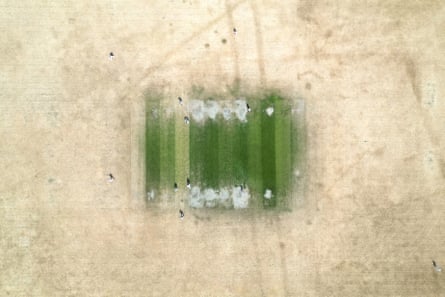 The green square amid the brown outfield during a match at Maidenhead and Bray cricket club in Berkshire.Photograph: Justin Tallis/AFP/Getty Images