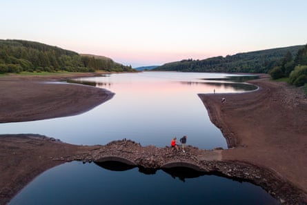 A two-arched stone bridge thought to date to 1800 at the Llwyn-onn reservoir in the Taf Fawr valley in Merthyr Tydfil, Wales was exposed by low water levels last week.Photograph: Matthew Horwood/Getty Images