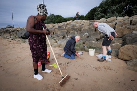 Volunteers search for nurdles.Photograph: Mark Pinder/The Guardian