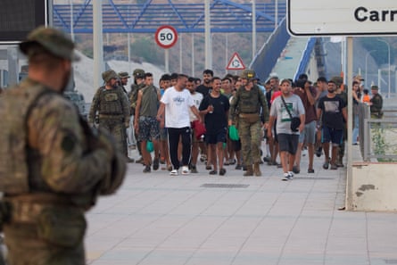 People who crossed into Ceuta this week are escorted back to Morocco by the Spanish army on Saturday.Photograph: Antonio Sempere/AP