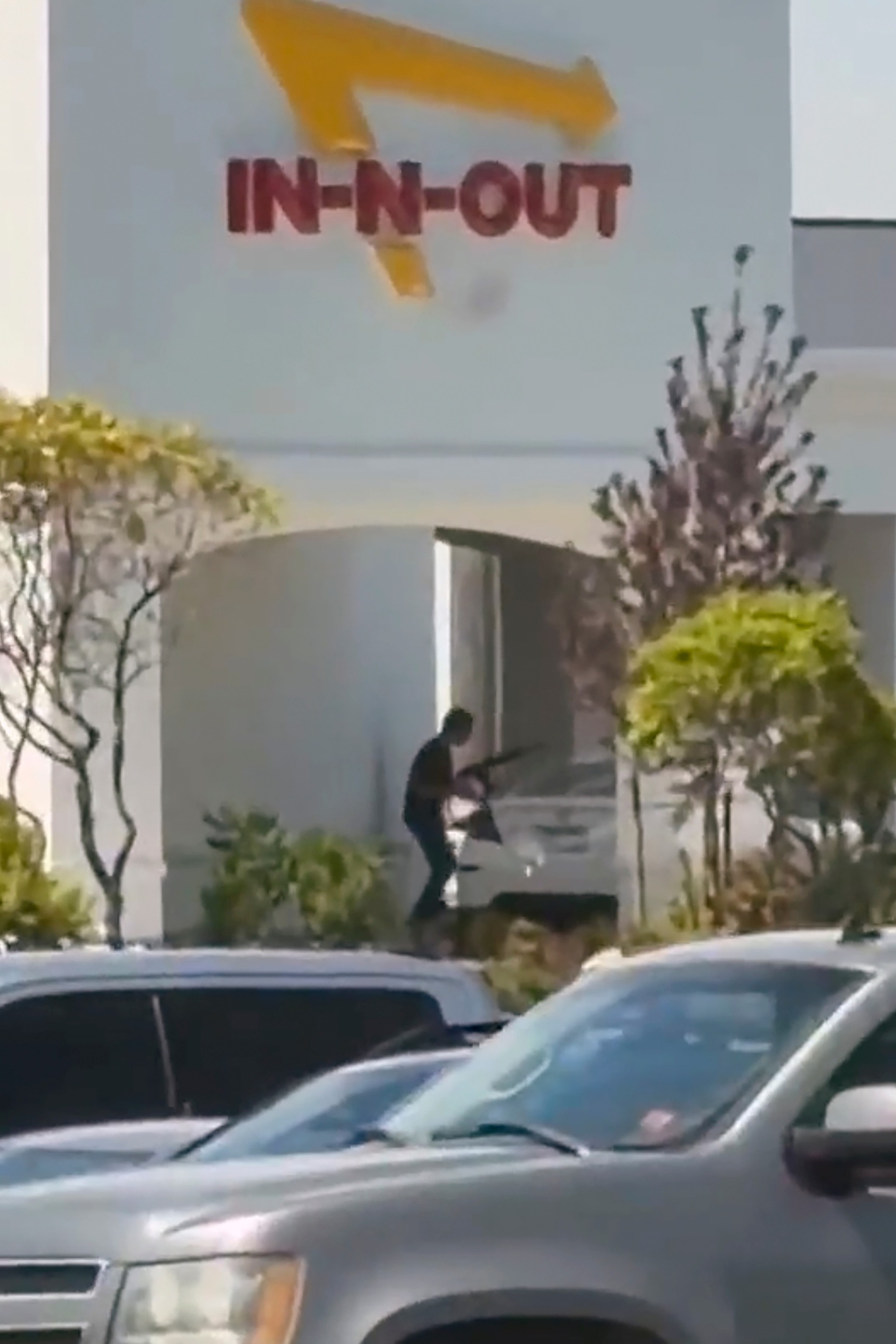 A bystander video verified by ABC News shows an alleged gunman preparing to open fire on a vehicle, Aug. 1, 2026, near an In-N-Out Burger restaurant in Twin Falls, Idaho.Unavailable