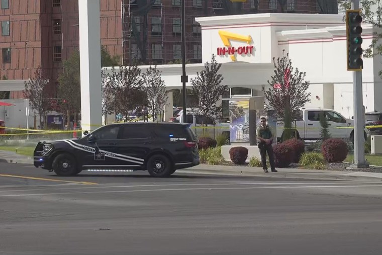 A law enforcement officer stands outside In-N-Out Burger restaurant where the shooting was reported Saturday.KTVB