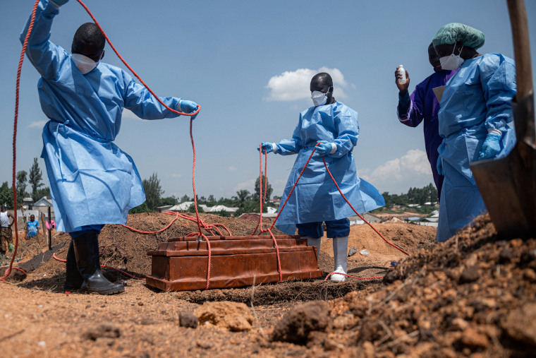 Aid workers prepare for a burial at Mbiyo cemetery in Ituri Province, Democratic Republic of the Congo, on June 19.Jospin Mwisha / AFP via Getty Images file